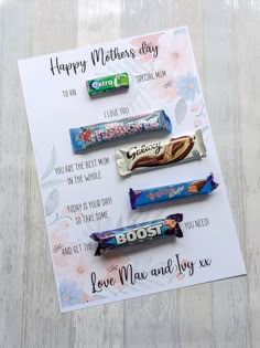 some candy bars are laying on top of a card that says happy mother's day