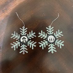 two snowflakes are hanging on a table