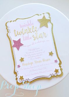 a white plate topped with a pink and gold baby shower