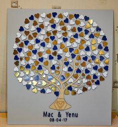 a wedding guest book with hearts on it and a tree made out of glass in the shape of hearts