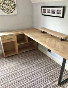 a corner desk with two open shelves on the side and a striped rug in front of it