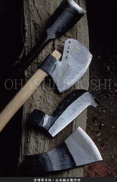 several different types of hammers and axes on a piece of wood with chinese writing