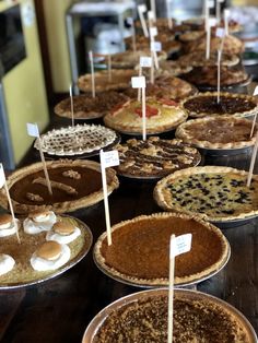 many pies are lined up on the table