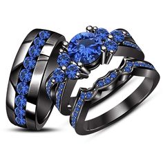 two black gold rings with blue sapphire stones on each side and an engagement ring in the middle