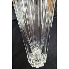 a clear glass vase sitting on top of a black table