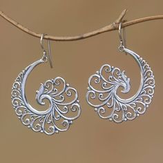 Balinese artisan Made Mustika creates a lovely pair of dangle earrings. He crafts them of sterling silver featuring intricate curl motifs that seem to go on to infinity. A striking high-polish finish accentuates the earrings. Wire Jewelry Earrings, Jewelry Photography Styling, Filigree Jewelry, Silver Earrings Handmade, Sterling Silver Drop Earrings, Filigree Earrings, Handmade Wire Jewelry, Silver Dangle Earrings, Sterling Silver Filigree