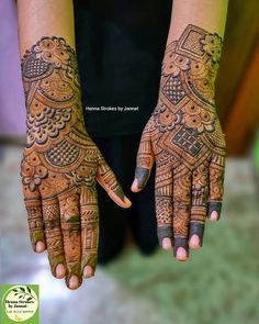 two hands with henna tattoos on them