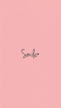 the word smile written in black ink on a pink background