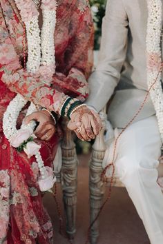 two people sitting next to each other on a chair