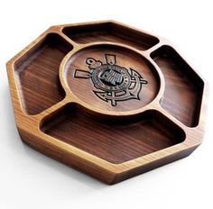 a wooden tray with an emblem on it