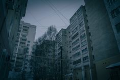 an empty street with tall buildings in the background