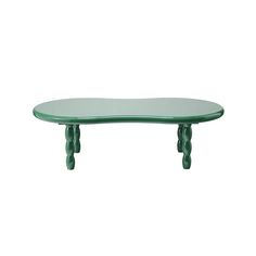 a green table sitting on top of a white wall