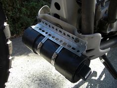 the rear end of a motorcycle with its exhaust system on it's back tire