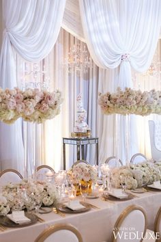 a table set up with flowers and candles for an elegant wedding reception at the four seasons hotel