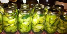 several jars filled with pickles sitting on top of a table