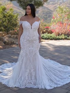 a woman in a wedding dress posing for the camera