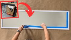 a woman is using a tape to measure the length of a large framed wall mirror