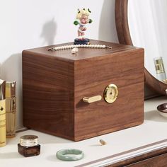 a wooden box with a figurine on top of it next to other items