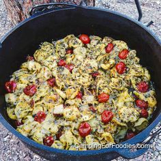 Pesto Tortellini Bake Freezer Meal by CampingForFoodies features a black cast iron Dutch oven filled with cubed chicken, red cherry tomatoes and cheese-filled tortellini pasta in a creamy pesto and alfredo sauce. The family-style meal has been baked and is ready to be served. Pesto Tortellini Bake, Grill Dishes, Camping Appetizers, Camping In Cold Weather, Frozen Tortellini, Camp Dinner, Easy Camping Breakfast, Dutch Oven Pot Roast