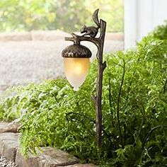 a lamp is sitting in the middle of some plants