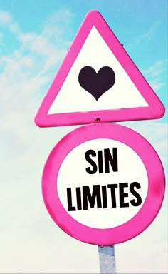 a pink and white street sign that says sin limites with a black heart on it