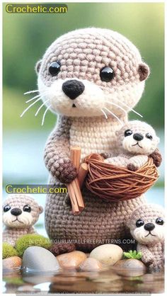 a crocheted otter holding a nest with two baby otters sitting on it