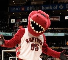 the raptors mascot is in action on the court