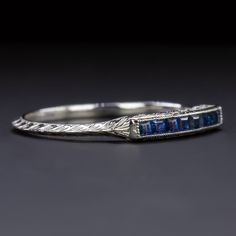 a silver ring with blue stones on it