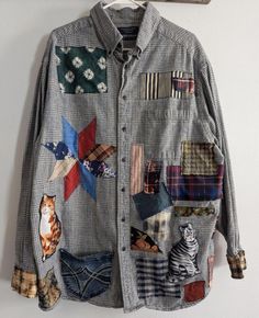 a button up shirt with patches and cats on it