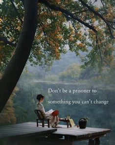 a woman sitting on a bench next to a tree with a quote above her that reads, don't be a prisoner to something you can't change