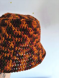 a crocheted hat is displayed on a mannequin's dummy head