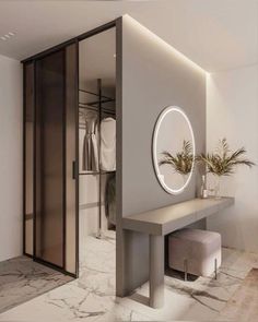 a bathroom with a mirror, stool and plant on the counter in front of it