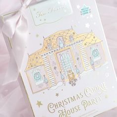 a christmas cookie house party box with pink ribbon