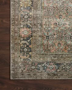 an antique persian rug is shown on a wooden floor with dark wood floors and brown walls