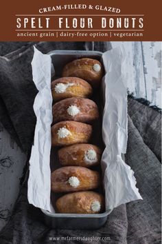 a box filled with lots of doughnuts covered in cream