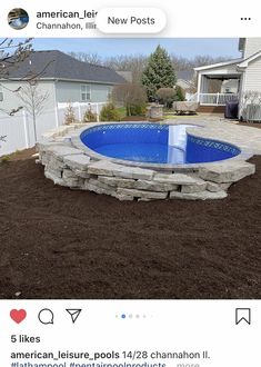 an empty pool surrounded by brown mulch