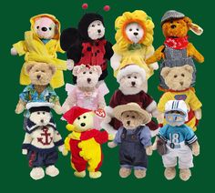 a group of teddy bears dressed up in different outfits and hats, all standing next to each other