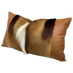 a brown and white pillow with fur on it