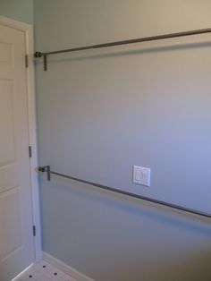 an empty bathroom with a white door and tile flooring on the wall next to it