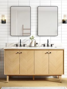 a bathroom with two mirrors above the sinks and a rug on the floor next to it