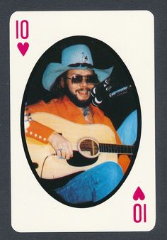 a man in a cowboy hat playing a guitar