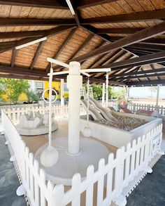 an outdoor play area with swings and slides