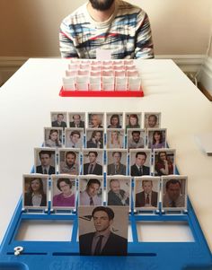 a man sitting in front of a table with many pictures on it and a blue tray