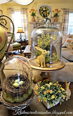 a clochet filled with fake plants and eggs under a glass dome on top of a table