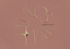 a clock made out of knitting needles on a pink background with the word love spelled in it