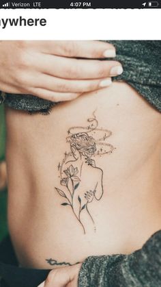 a woman with a flower tattoo on her stomach