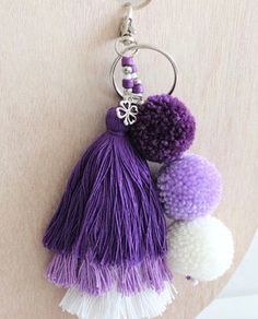 two tasselled pom poms hanging from a keychain