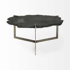 a table made out of wood with metal legs and a black slab on the top