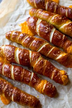 croissants are lined up on wax paper and ready to be baked in the oven