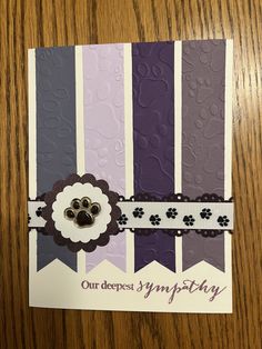 a close up of a greeting card on a table with a wooden surface in the background